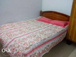 Brown Wooden Bed And Pink Floral Bedspread Set