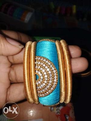 Five Gold-colored And Blue Silk-thread Bangles