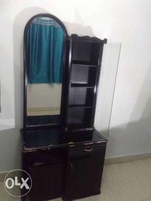It's a black coloured dressing/vanity table with