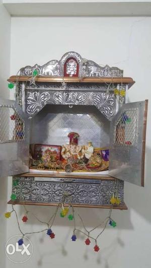 Its a two door bhagwan mandir with silver finish,