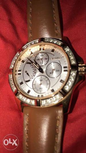 Round Gold-colored Seiko Chronograph Watch With Brown