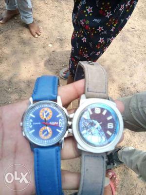 Two Round Silver Chronograph Watches With Blue Leather