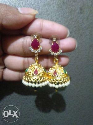 Pair Of Gold-colored Red Gemstone Jhumka Earrings