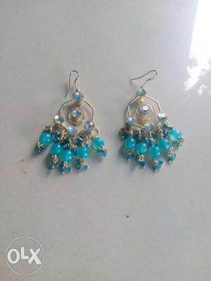 Pair Of Silver-colored Pendant Earrings With Blue Gemstones
