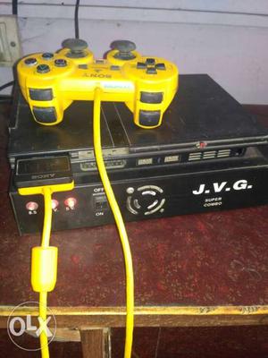Black Sony PS2 Console With Yellow Corded Game Controller