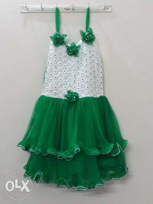 Girl's green and pretty frock in New condition.