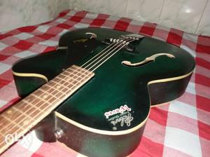 Green And Black Semi-acoustic Guitar