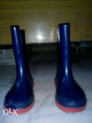 Pair Of Blue Rubber Rain Boots for kids.