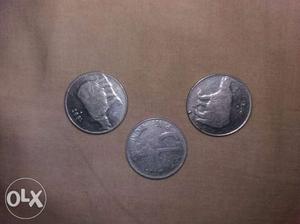 Round Three Silver-colored 25 Indian Paise Coins
