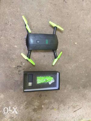 Black And Green Quadcopter With Remote