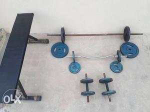 GYM EQUIPMENT (Iron weights) and a bench.
