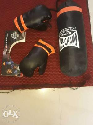Pair Of Black Boxing Gloves And Heavy Bag