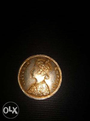 Round Gold-colored Victoria Empress Coin