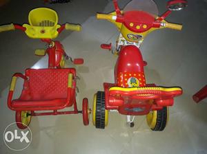 Toddler's Two Red-and-yellow Trikes