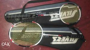 Two White-and-black Badminton Rackets With Cases