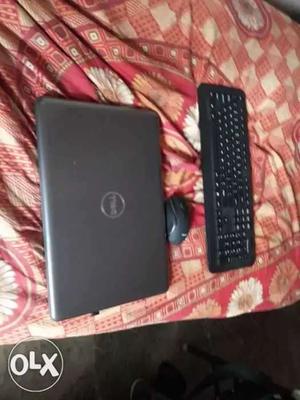 Gray Dell Laptop; Black Wireless Computer Keyboard; Black