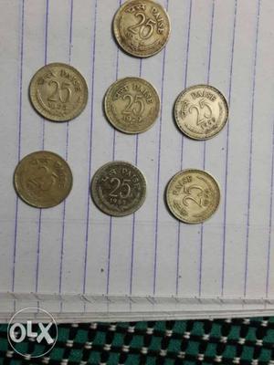 Seven Gold-colored 25 Indian Paise Coins