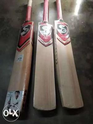 Three Brown-and-red Cricket Bats