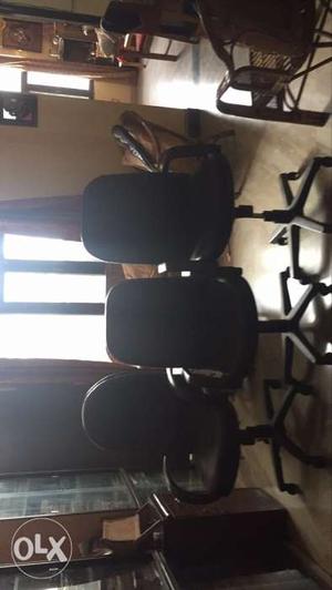 Three revolving black chairs  each