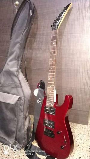 Red And Black Electric Guitar With Black Guitar Case