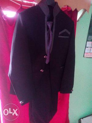 Black coat and pent with a tie