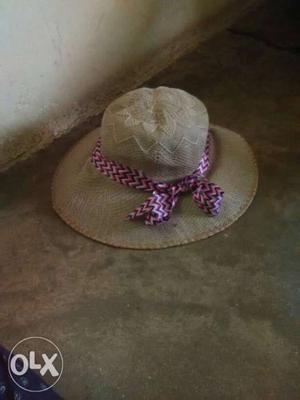 Goof condition jute cap with pink ribbon