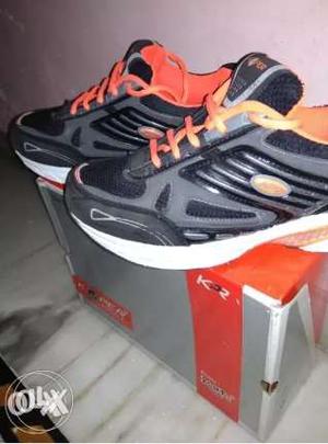 Pair of brand new black and orange sport shoes