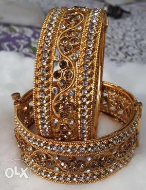 Two Gold-colored Bangle Bracelets With Clear Gemstones