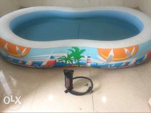 White, Blue, And Orange Inflatable Pool