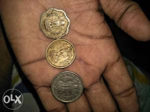 Several Silver-and-gold-colored 25 Indian Paise Coins