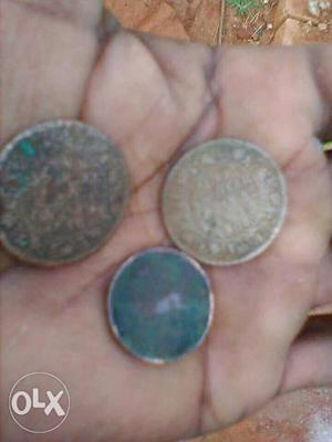 Three Round Copper-colored Indian Coins
