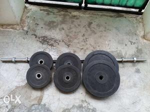 Two Black Weight Plates And Two Dumbbells