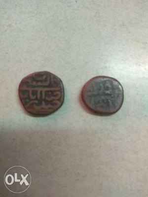 Two Round Copper-colored Mughal Coins