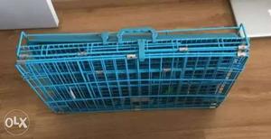Blue metallic foldable dog cage going cheap.