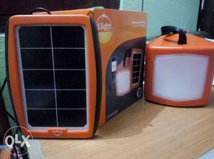 Orange, Black, And White Solar Panel With Box