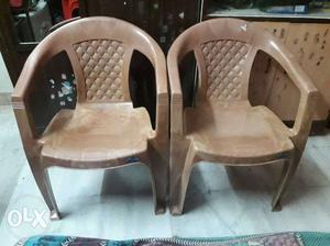 Two Brown Monobloc Armchairs