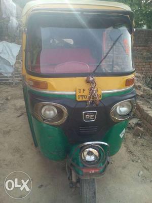 Yellow And Green Bajaj RE Auto Rickshaw