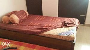 One single bed diwan with a branded kurl on