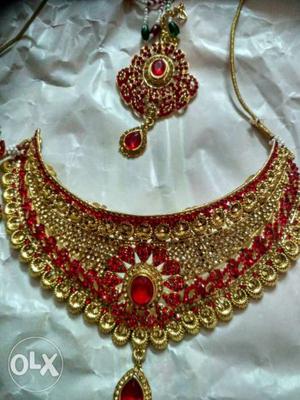 Gold-colored Necklace With Red Gemstone