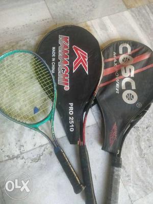 Three Black, Red, And Green Tennis Rackets