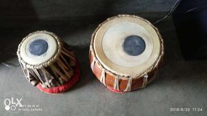 Two Brown-and-white Musical Drums