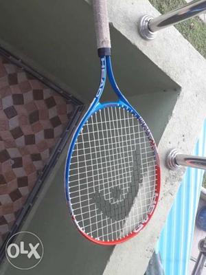 Blue, Brown, And Orange Head Tennis Racket