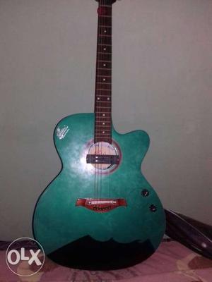 Green And Brown Cutaway Acoustic Guitar