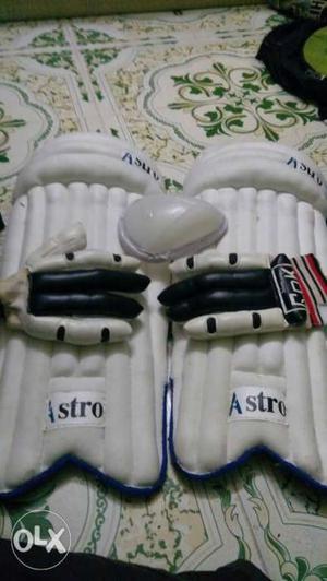 Pair Of White Shin Guards And Black-and-white Reebok Gloves