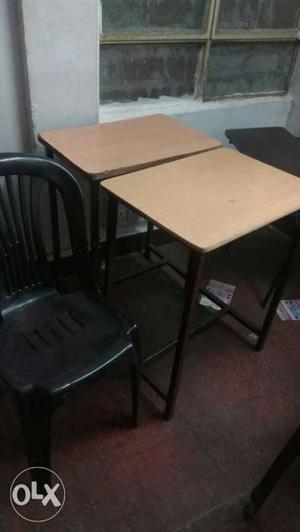 Two Brown Wooden Tables And Black Plastic Chair