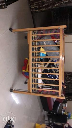 Wooden baby cot with cushions for sale