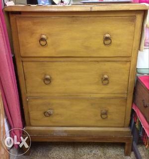 A wooden chester with three huge drawers