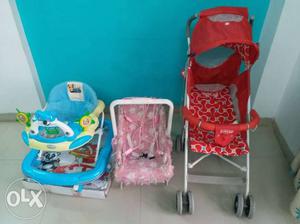 Baby's Red And White Stroller And Pink Seat Carrier