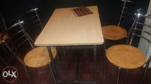 Wooden tables and stainless steel chairs with wooden top