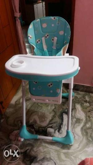 Baby's White And Teal High Chair
